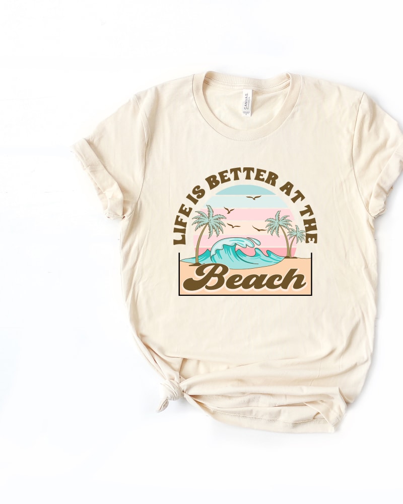 Front of a model wearing a size 2XL Better At The Beach Wave Short Sleeve Graphic Tee in Cream by Simply Sage Market. | dia_product_style_image_id:301139